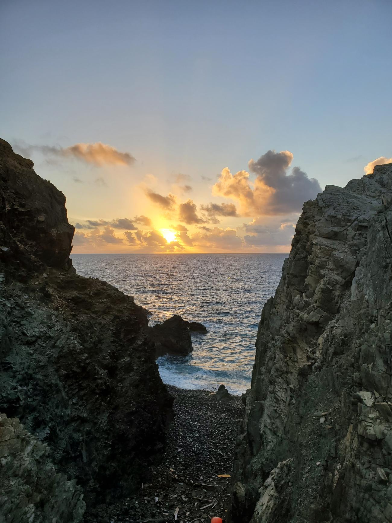 Sunrise over the sea framed by the cliffs at Rams Head, St. John